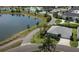 Beautiful aerial view of a lakeside home in a community with walking paths and a community pool at 744 Barron Pl, The Villages, FL 32163