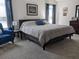 Spacious bedroom featuring a large bed and chair with soft natural light and neutral colored carpet at 744 Barron Pl, The Villages, FL 32163