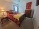 Bright bedroom with yellow blanket, floral bedding, and wood dresser at 744 Barron Pl, The Villages, FL 32163