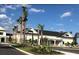 Exterior of a community building with palm trees, surrounded by landscaped grounds at 744 Barron Pl, The Villages, FL 32163