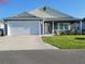 Charming single-story home with a two-car garage and well-maintained front yard under a clear blue sky at 744 Barron Pl, The Villages, FL 32163