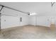 Spacious two-car garage featuring neutral walls and floors, and an automatic door at 744 Barron Pl, The Villages, FL 32163
