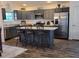 Modern kitchen featuring a large island, stainless steel appliances, and abundant cabinet space at 744 Barron Pl, The Villages, FL 32163