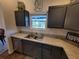 Functional kitchen showcasing stainless steel sink, ample counterspace, and natural light at 744 Barron Pl, The Villages, FL 32163