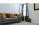 This living room features a grey sofa with colorful pillows and a window with black out curtains at 744 Barron Pl, The Villages, FL 32163
