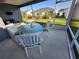 A screened patio features a glass table and chairs with views of the backyard at 744 Barron Pl, The Villages, FL 32163