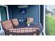 Inviting covered patio featuring comfortable seating and a wall-mounted television at 744 Barron Pl, The Villages, FL 32163