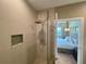 Bright bathroom with a glass shower enclosure, offering a peek into the bedroom at 7528 Brooklyn Dr, Kissimmee, FL 34747