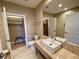Modern bathroom with tile floors, a walk-in closet and granite countertop vanity at 7528 Brooklyn Dr, Kissimmee, FL 34747