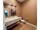 Modern bathroom featuring a floating sink and wood-look tile floors at 7528 Brooklyn Dr, Kissimmee, FL 34747
