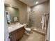 Neutral colored bathroom with a glass shower, light counter and modern fixtures at 7528 Brooklyn Dr, Kissimmee, FL 34747
