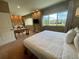 Spacious bedroom featuring a large window, desk, and sitting area with neutral colored walls at 7528 Brooklyn Dr, Kissimmee, FL 34747