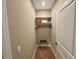 Small closet with rack and shelf provides storage space for clothing and luggage rack at 7528 Brooklyn Dr, Kissimmee, FL 34747
