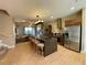 The kitchen features an island with barstool seating, stainless steel appliances, and hardwood floors at 7528 Brooklyn Dr, Kissimmee, FL 34747