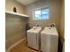 Laundry room with washer, dryer, and bright window for natural light at 7528 Brooklyn Dr, Kissimmee, FL 34747