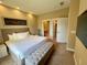 Cozy main bedroom with ensuite bathroom and large TV at 7528 Brooklyn Dr, Kissimmee, FL 34747