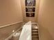 Well-lit staircase with neutral carpet and wall art, creating a welcoming transition between floors at 7528 Brooklyn Dr, Kissimmee, FL 34747
