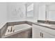 Relaxing bathroom features a soaking tub with stone tile and a vanity with a gray countertop at 9175 Sommerset Hills Dr, Davenport, FL 33896