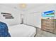 bedroom with a fluffy blue blanket, TV, and a wooden dresser at 9175 Sommerset Hills Dr, Davenport, FL 33896