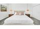 Beautiful bedroom featuring a king bed, modern lighting fixtures, and an accent painting at 9175 Sommerset Hills Dr, Davenport, FL 33896