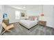 Well-lit bedroom with a queen bed, ceiling fan, and gray carpet flooring at 9175 Sommerset Hills Dr, Davenport, FL 33896