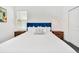 Comfortable bedroom featuring a plush bed, wood nightstands, and pendant lighting at 9175 Sommerset Hills Dr, Davenport, FL 33896