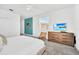 Bright bedroom features a neutral color palette, a ceiling fan, a dresser, and a window at 9175 Sommerset Hills Dr, Davenport, FL 33896