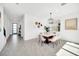 Bright dining room features modern chandelier, decor art and a clear view into the foyer at 9175 Sommerset Hills Dr, Davenport, FL 33896