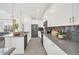Bright kitchen with stainless steel appliances, gray countertops, and pendant lighting at 9175 Sommerset Hills Dr, Davenport, FL 33896