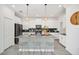 Open kitchen with white cabinets, stainless appliances, and a patterned central island at 9175 Sommerset Hills Dr, Davenport, FL 33896