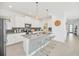 Contemporary kitchen boasts white cabinets, stylish island, and stainless steel appliances at 9175 Sommerset Hills Dr, Davenport, FL 33896