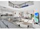 Bright, open-concept living space with a large couch that connects to the kitchen and dining area at 9175 Sommerset Hills Dr, Davenport, FL 33896