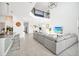 Open-concept living space with a large couch, modern kitchen and a clear view into the dining area at 9175 Sommerset Hills Dr, Davenport, FL 33896