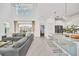 Spacious living area with soaring ceilings, modern decor, and an open layout connecting the kitchen at 9175 Sommerset Hills Dr, Davenport, FL 33896