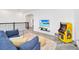 This loft boasts a comfortable sofa, wall-mounted television, and a fun arcade game at 9175 Sommerset Hills Dr, Davenport, FL 33896
