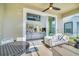 Relaxing covered patio with outdoor seating and view of the living room at 9175 Sommerset Hills Dr, Davenport, FL 33896