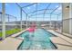Enclosed pool area with clear blue water, a safety fence, and outdoor space at 9175 Sommerset Hills Dr, Davenport, FL 33896