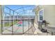 Relaxing outdoor patio with grill and view of the pool and backyard area at 9175 Sommerset Hills Dr, Davenport, FL 33896