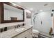 Bathroom features granite countertop, framed mirror, and tile shower at 108 Crown Oaks Way, Longwood, FL 32779