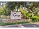 Charming entrance to The Springs community with stone accents and lush landscaping at 108 Crown Oaks Way, Longwood, FL 32779