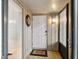 Entryway with white door, 'hello' mat, and accent wall light at 108 Crown Oaks Way, Longwood, FL 32779