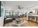 Open living room featuring wood floors, modern furniture, and a kitchen area at 108 Crown Oaks Way, Longwood, FL 32779
