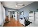 Spacious bedroom featuring hardwood floors, a ceiling fan, and a mirrored closet at 1105 Apple Ter, Leesburg, FL 34748