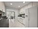 White kitchen featuring stainless steel appliances and eat-in space with natural light at 1105 Apple Ter, Leesburg, FL 34748