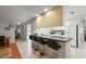 Bright kitchen features a breakfast bar with seating, white appliances, and tiled floors at 1105 Apple Ter, Leesburg, FL 34748