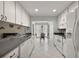 Well-lit kitchen features white appliances, ample cabinet space, and an adjacent dining area at 1105 Apple Ter, Leesburg, FL 34748