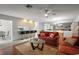Cozy living room features hardwood flooring, comfortable seating, and a ceiling fan at 1105 Apple Ter, Leesburg, FL 34748