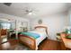 Bright main bedroom with hardwood floors, mirrored closet doors, and updated decor at 1105 Apple Ter, Leesburg, FL 34748