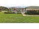 Enjoy outdoor living on this screened patio with views of the manicured lawn and lush landscaping at 1105 Apple Ter, Leesburg, FL 34748