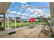 Enclosed patio with outdoor seating, offering a relaxing space with views of the manicured backyard at 1105 Apple Ter, Leesburg, FL 34748